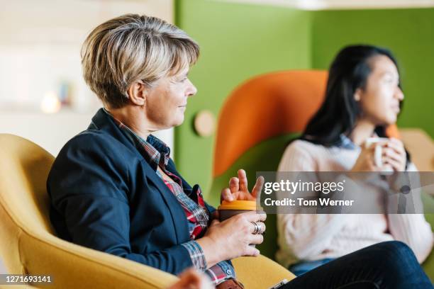 some office employees talking while having coffer break - coffee break party stock-fotos und bilder