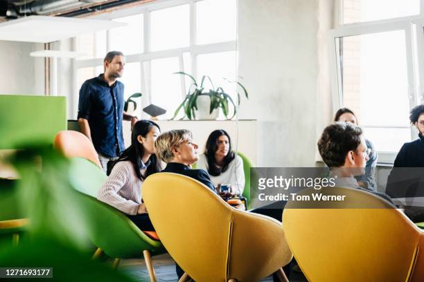 office meeting with employees listening to manager - corporate modern office bright diverse stock pictures, royalty-free photos & images