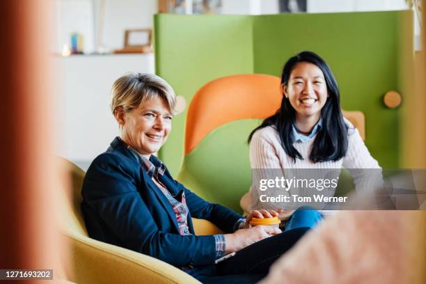 business owner meeting with some of her heads of staff - mature women portrait asian stock-fotos und bilder