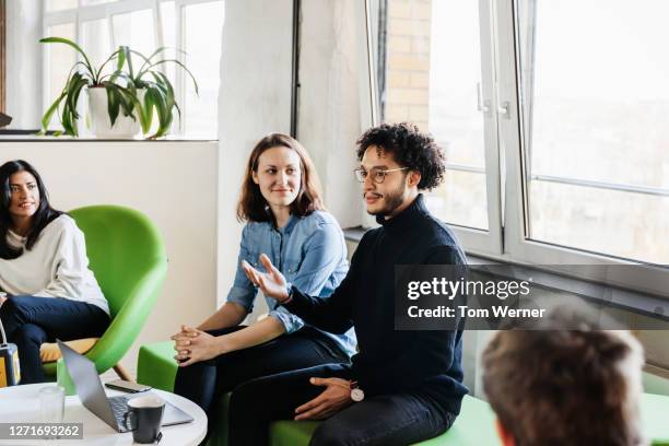 man talking during business meeting in office with colleagues - leadership listening stock-fotos und bilder