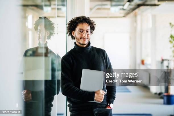 portrait of business manager holding laptop - selective focus stock-fotos und bilder