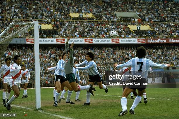 Daniel Pasarella of Argentina pushes Peru goalkeeper Acasuzo in the back during a World Cup qualifying match in Lima, Peru. Peru won the match 1-0. \...