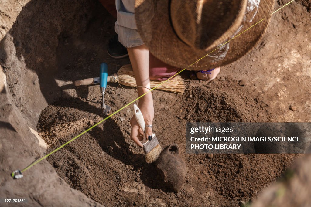 Archaeologist excavating pottery