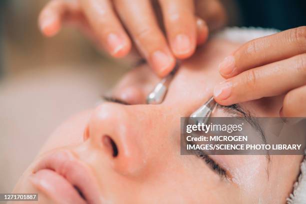 facial using drainage sticks - dark circle eye stock pictures, royalty-free photos & images