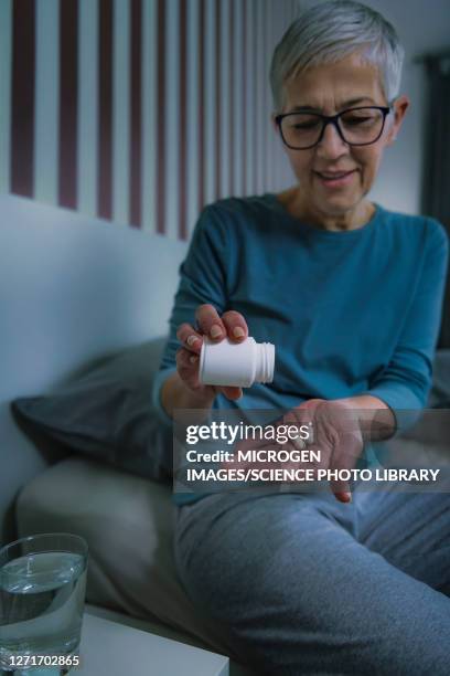 woman taking melatonin pills - melatonin stock pictures, royalty-free photos & images