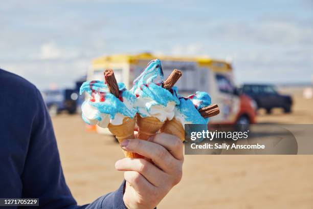 man holding ice cream cones - ice cream sprinkles stock pictures, royalty-free photos & images