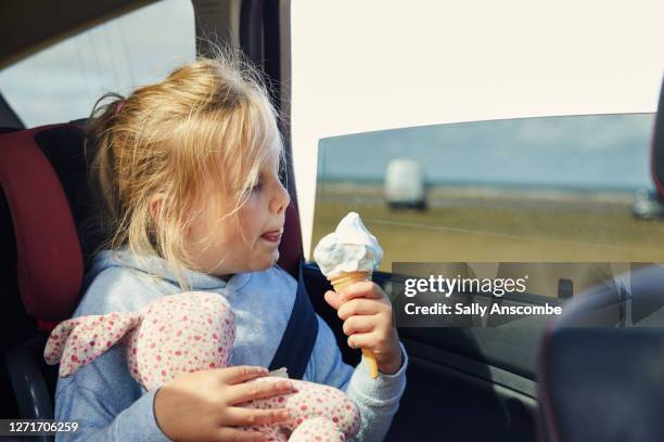 child eating an ice cream in a car - eating in car stock pictures, royalty-free photos & images