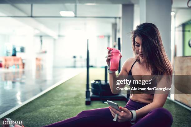 hydrating and relaxing after workout is a habit of female athlete - hip flask stock pictures, royalty-free photos & images