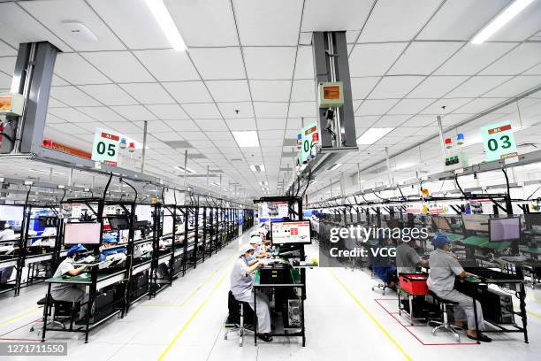 Employees work on the production line of Motorola Razr 5G foldable smartphones at Lenovo Mobile and Internet Base on September 10, 2020 in Wuhan,...