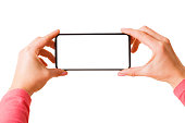 Person holding in hands smartphone with blank screen and taking picture or recording video