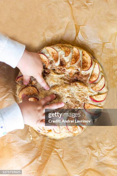 sweet homemade apple pie on craft paper. baby touching apple pie. - almond caramel stock pictures, royalty-free photos & images