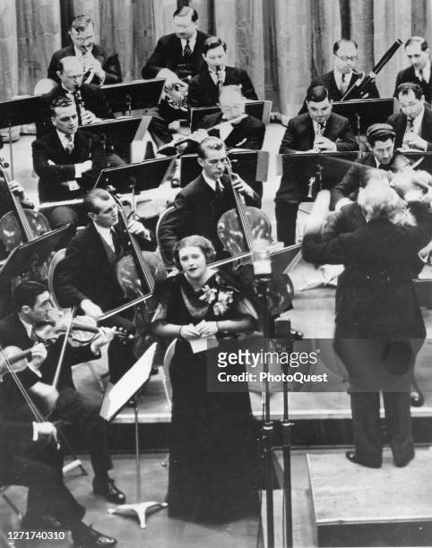 German-born soprano Lotte Lehmann performs with Italian conductor Arturo Toscanini and an unspecified orchestra for a radio broadcast as part of the...