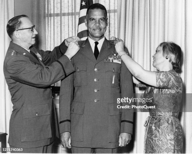 Air Force Chief of Staff General John P McConnell pins a third star on the uniform of Lieutenant General Benjamin O Davis Jr with the assistance of...