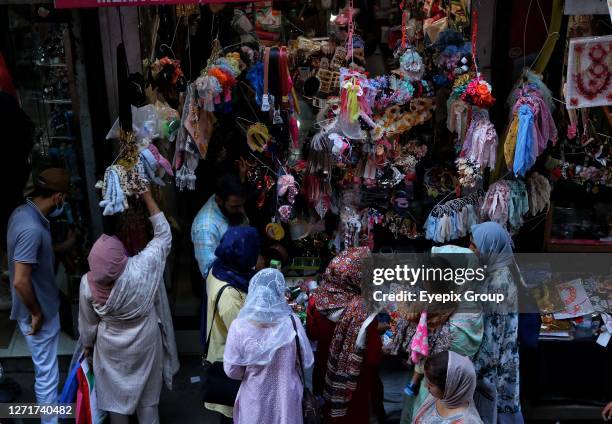 June 26 Srinagar Kashmir, India : People shop at a market ahead of Eid-Al-Adha festival in Srinagar. Muslims around the world celebrate Eid-Al-Adha...