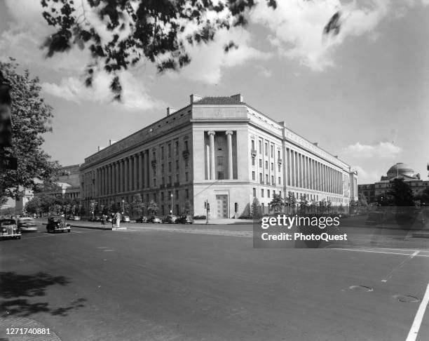 Exterior view of the Department of Justice Building, at the intersection of Pennsylvania Avenue and 10th NW, Washington DC, circa 1940. Visible in...