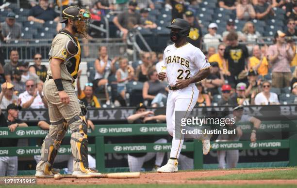 Andrew McCutchen of the Pittsburgh Pirates comes around to score on a RBI single by Henry Davis in the sixth inning during the game against the San...