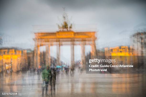 multiple exposure with abstract motion blur effect of the brandenburg gate - quadriga statue brandenburg gate stock-fotos und bilder