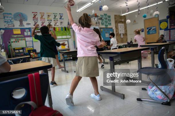 Harper Shea , exercises with fellow students in class during their first day of kindergarten on September 9, 2020 in Stamford, Connecticut. For...