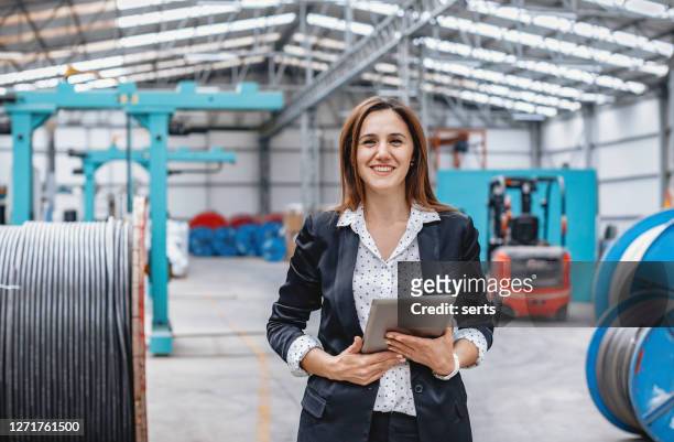 portrait of factory manager woman using tablet - factory engineer woman stock pictures, royalty-free photos & images