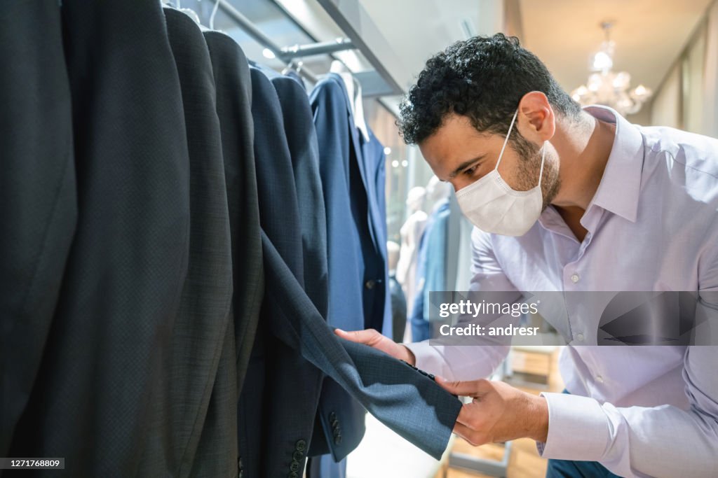 Handsome man buying formal clothes at a store