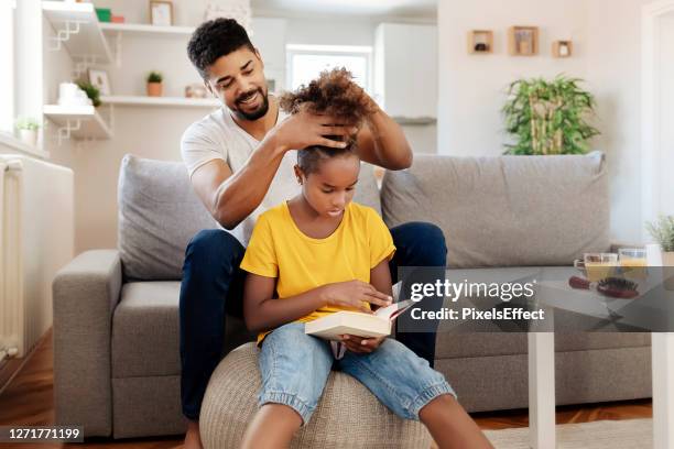 grooming his little one - man combing hair stock pictures, royalty-free photos & images