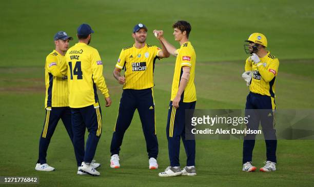 Calvin Harrison of Hampshire celebrates with teammates after taking the wicket of Ravi Bopara of Sussex during the Vitality Blast match between...