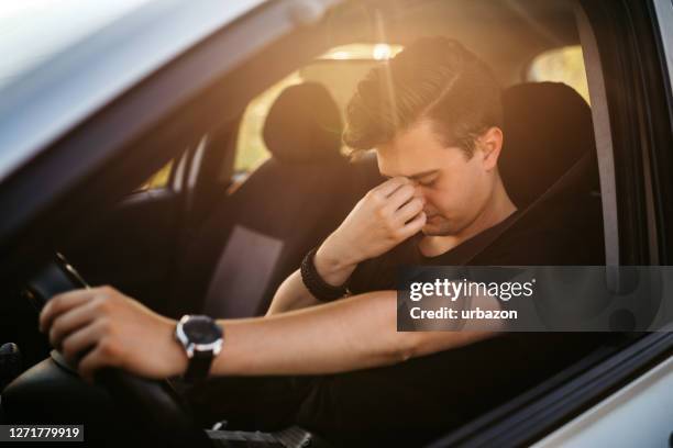 having a headache while driving car - tired driver stock pictures, royalty-free photos & images