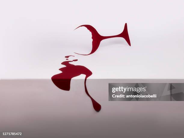 conceptual red wine glass with spilled wine - spilled drink stock pictures, royalty-free photos & images