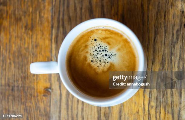 cup of espresso coffee on a wooden table - americano stockfoto's en -beelden