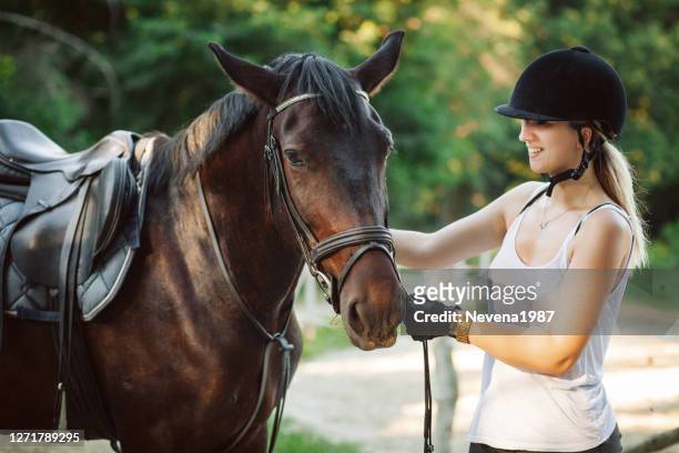 glückliche frau umarmt ihr pferd - stallion stock-fotos und bilder