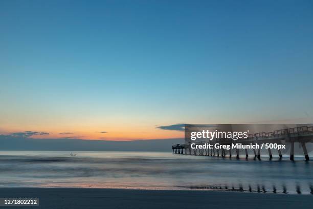 scenic view of sea against clear sky during sunset, jacksonville beach, united states - jacksonville beach stock pictures, royalty-free photos & images