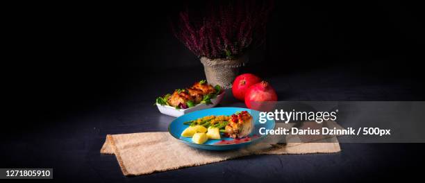 high angle view of food in plate on table against black background - granatapfel stockfoto's en -beelden