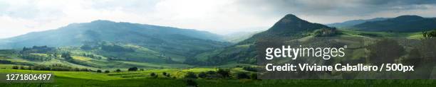 scenic view of mountains against sky, san gimignano, italy - viviane caballero stockfoto's en -beelden