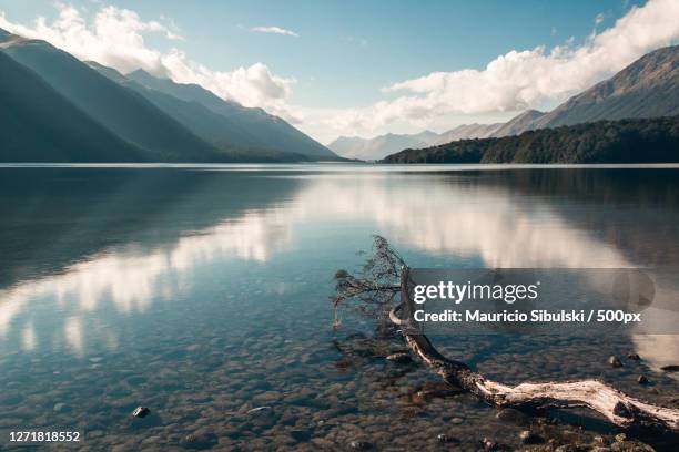 scenic view of lake by mountains against sky, te anau, new zealand - te anau stock pictures, royalty-free photos & images