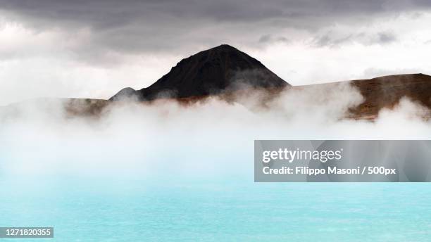 scenic view of hot spring against cloudy sky, laugar, iceland - sulphur stock pictures, royalty-free photos & images