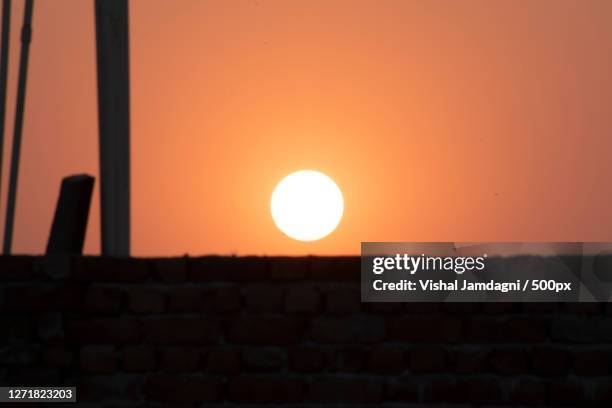 silhouette of building against sky during sunset, gurgaon, india - gurgaon stock-fotos und bilder