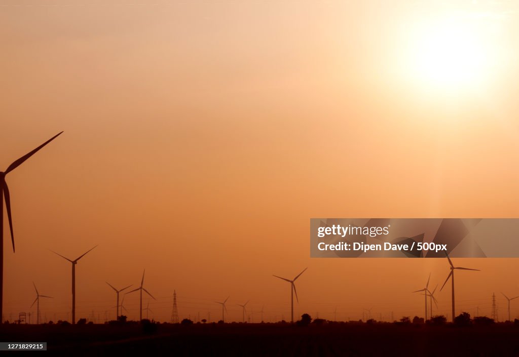 Silhouette Wind Turbines On Field Against Sky During Sunset, Srat, India