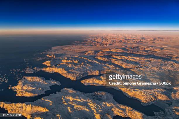 aerial view of landscape against blue sky, uummannaq, greenland - greenland uummannaq stock pictures, royalty-free photos & images