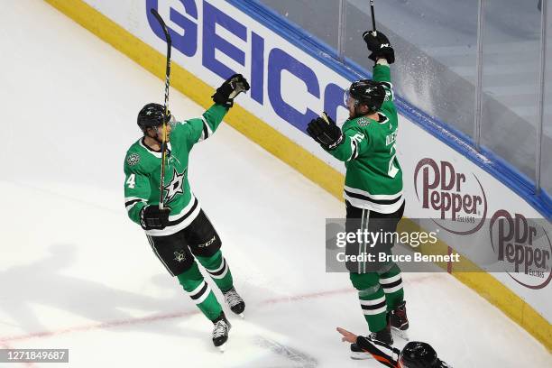 Jamie Oleksiak of the Dallas Stars is congratulated by Miro Heiskanen after scoring a goal against the Vegas Golden Knights during the second period...