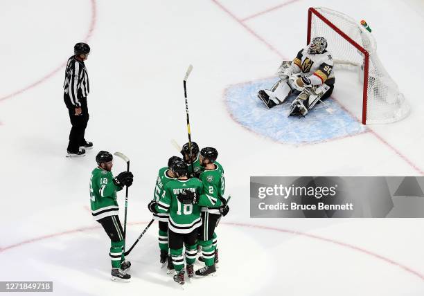 Jamie Oleksiak of the Dallas Stars is congratulated by his teammates after scoring a goal past Robin Lehner of the Vegas Golden Knights during the...