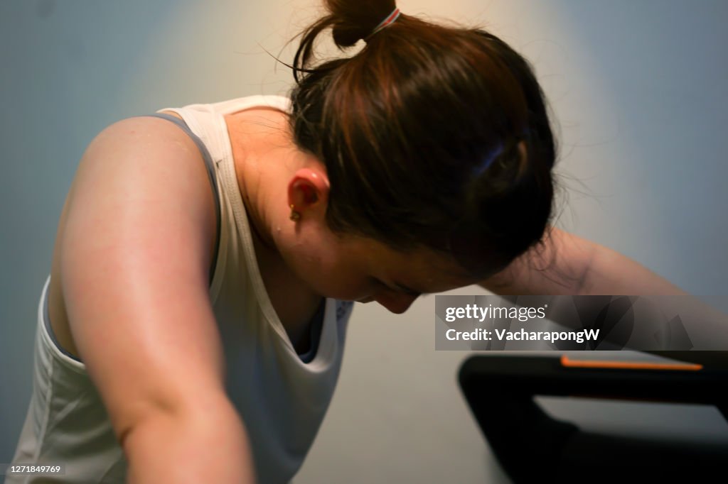 Tired woman jogger on treadmill