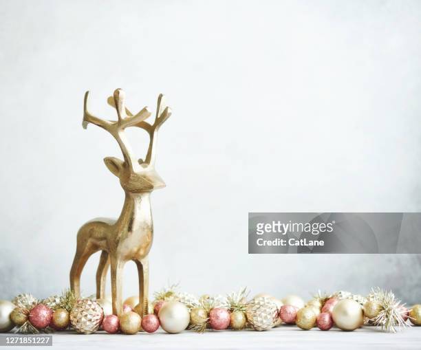 bright christmas background with rose pink and gold decorations with gold reindeer on white wood - brass frame stock pictures, royalty-free photos & images