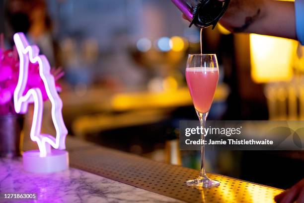 Bartender pours a cocktail for one of the guests during the "Henpire" podcast launch event at Langham Hotel on September 10, 2020 in London, England.