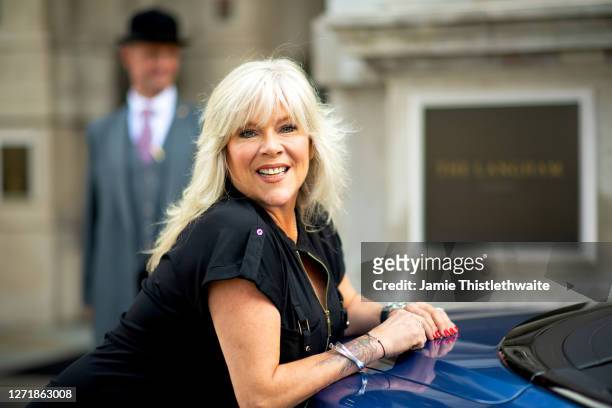 Samantha Fox poses with the rainbow Bentley during the "Henpire" podcast launch event at Langham Hotel on September 10, 2020 in London, England.