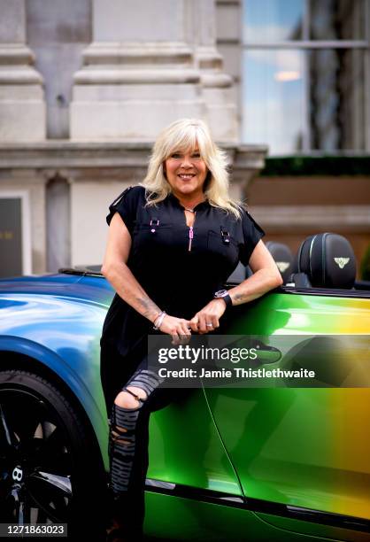 Samantha Fox poses with the rainbow Bentley during the "Henpire" podcast launch event at Langham Hotel on September 10, 2020 in London, England.