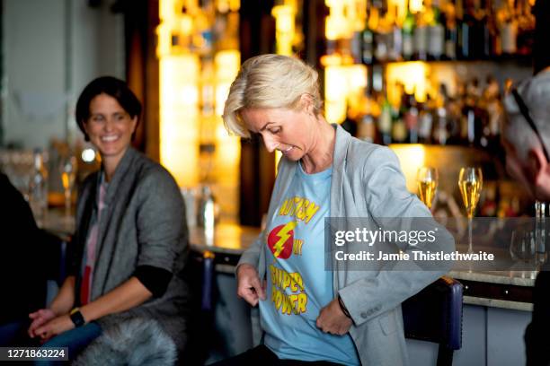 Samantha Grierson shows off her t-shirt to the audience on the Cast and Crew panel during the "Henpire" podcast launch event at Langham Hotel on...