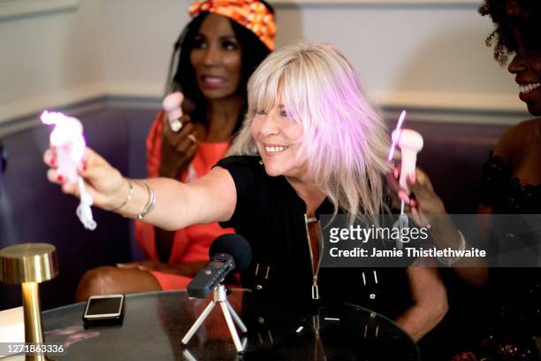 Samantha Fox poses with a neon mini fan during the "Henpire" podcast launch event at Langham Hotel on September 10, 2020 in London, England.