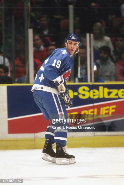 Joe Sakic of the Quebec Nordiques skates against New Jersey Devils during an NHL Hockey game circa 1990 at the Brendan Byrne Arena in East...