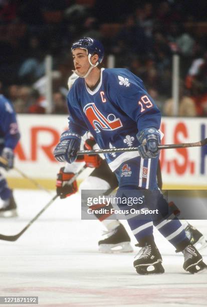 Joe Sakic of the Quebec Nordiques skates against New Jersey Devils during an NHL Hockey game circa 1993 at the Brendan Byrne Arena in East...