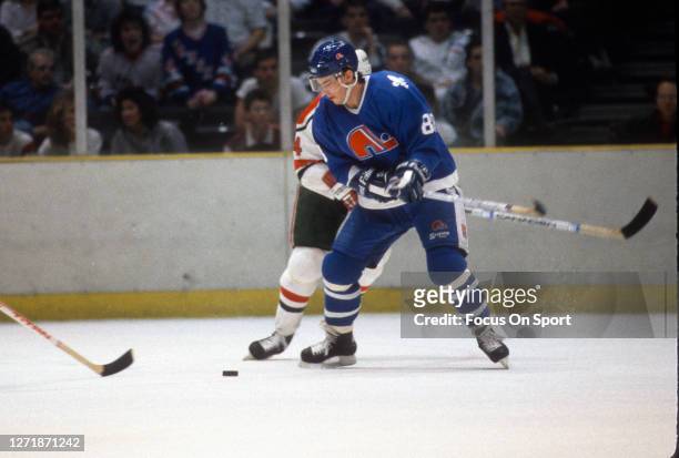 Joe Sakic of the Quebec Nordiques skates against New Jersey Devils during an NHL Hockey game circa 1989 at the Brendan Byrne Arena in East...